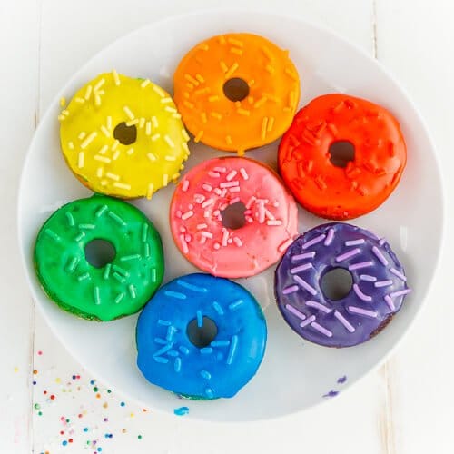 This rainbow donuts recipe is perfect for a rainbow party, St. Patrick's Day party food, or anytime you just need a little color in your life! Definitely one of the best rainbow foods and there's a secret ingredient that'll make you feel even better about eating them, way better than if you eat rainbow cake!