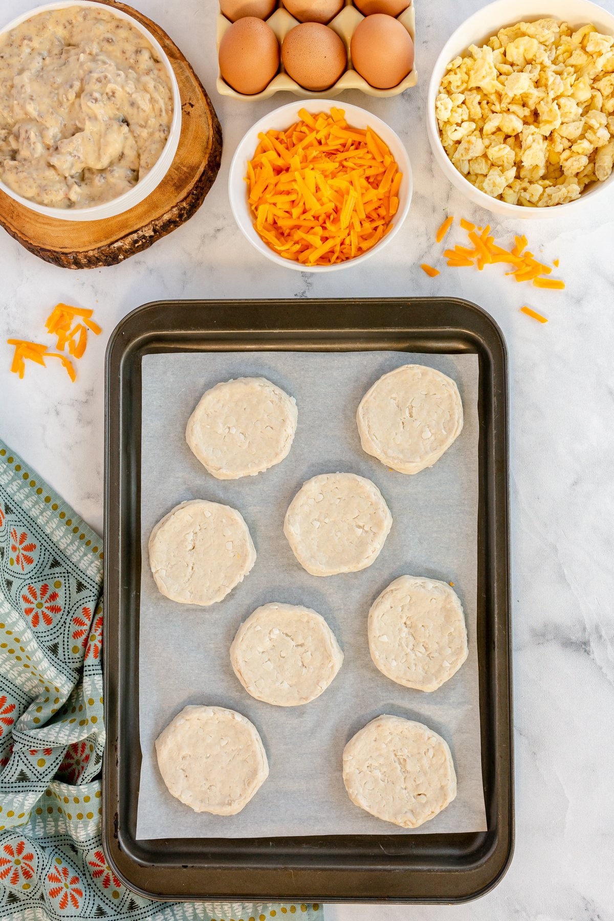 biscuits rolled out on a baking sheet