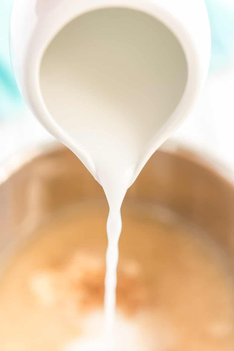 Adding ingredients in rice cooker for coconut rice