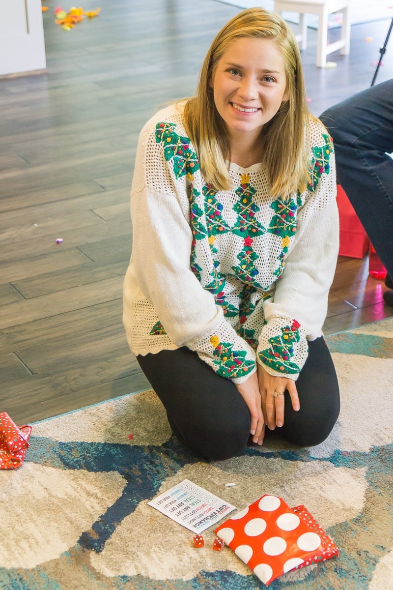 A girl playing switch steal unwrap gift exchange - one of the best gift exchange dice game ideas ever.