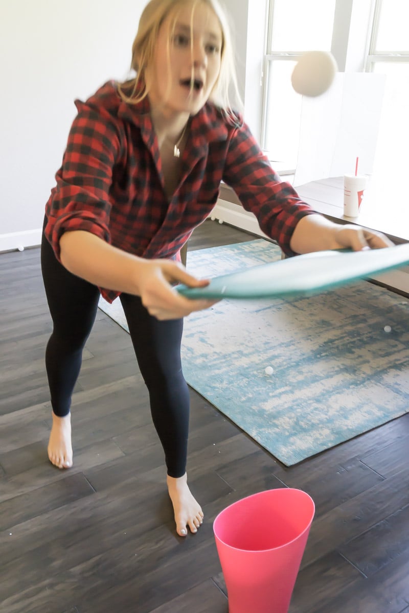 girl playing a winter olympic themed party game