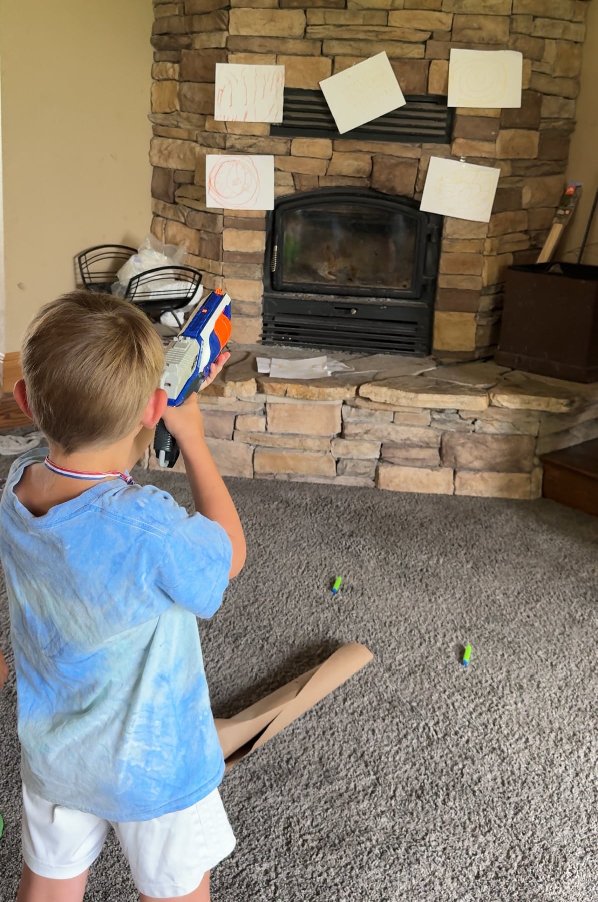 kid shooting a nerf gun at a target