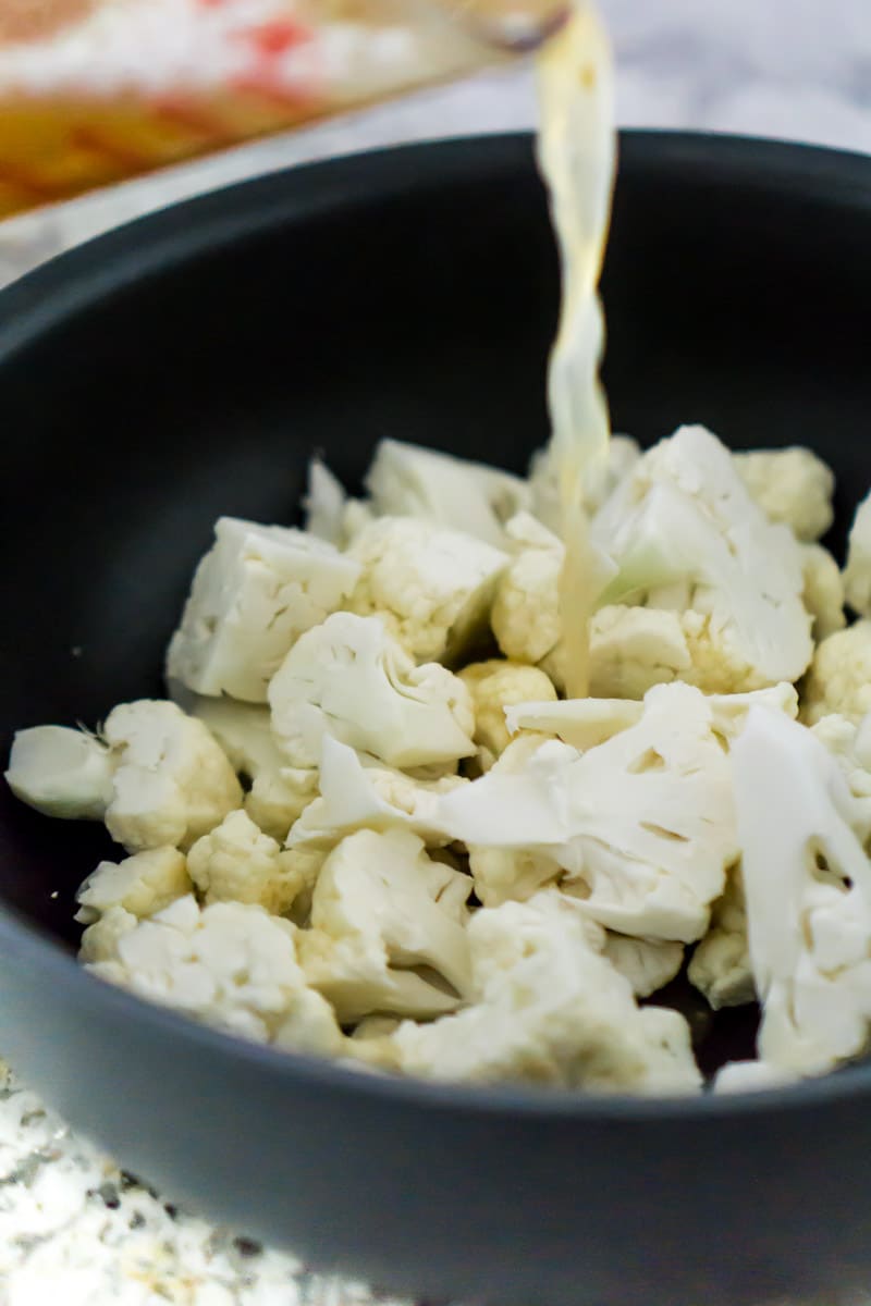 Mixing ingredients for cauliflower puree in a pot