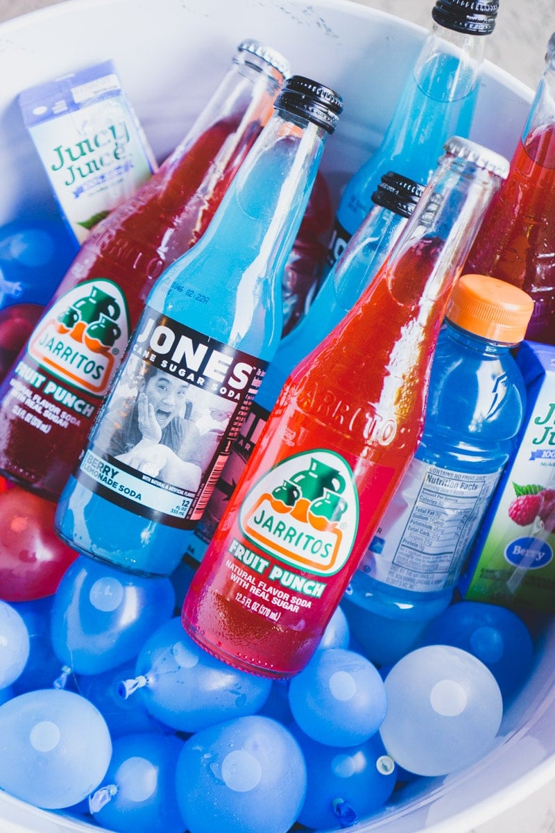 Red white and blue drinks in a tub full of water balloons at a 4th of July party