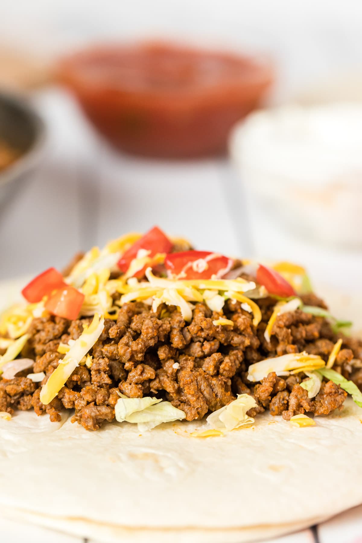 Homemade taco meat on a tortilla