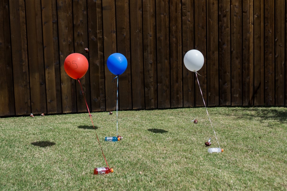 numbered balloons tied to Gatorade bottles laying in the grass