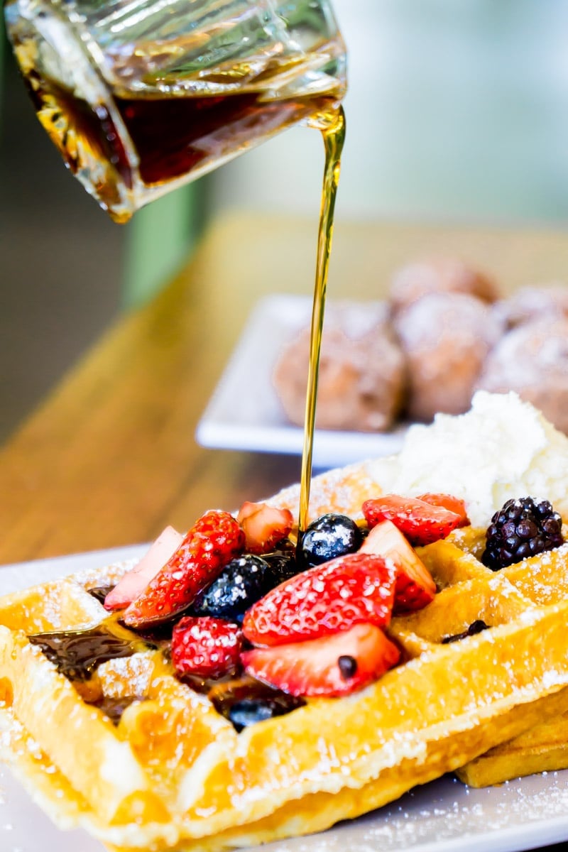 Syrup being poured onto waffles at Joe's Farm Grill