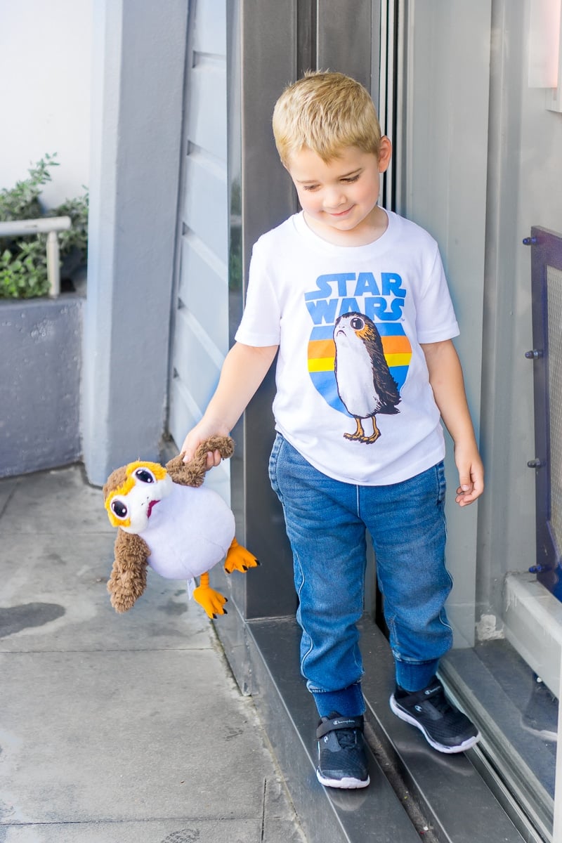 Kid holding Porg while getting ready for kindergarten