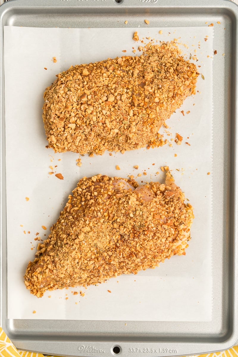 Almond encrusted chicken on a baking sheet