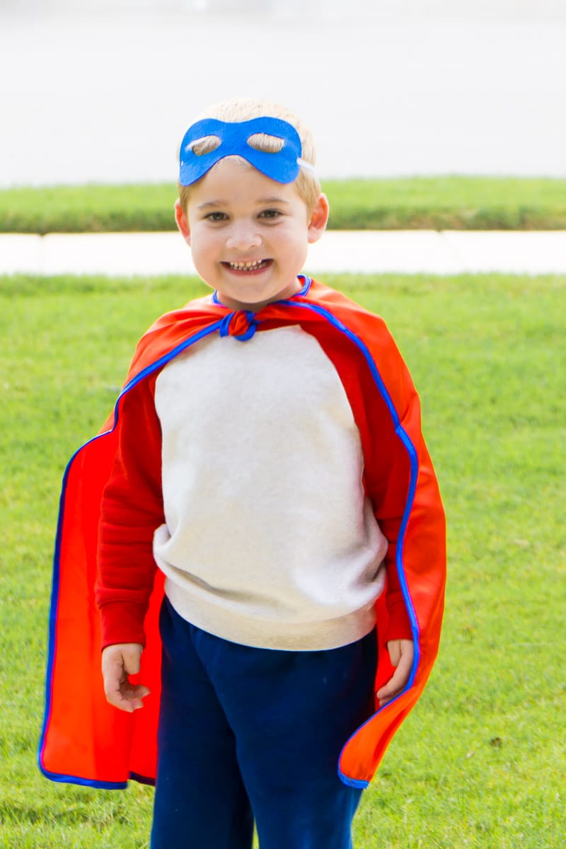 Boy who is happy with his DIY superhero costume