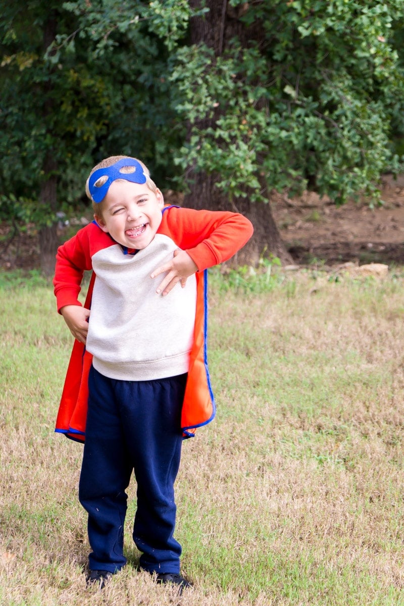 DIY superhero costume on a boy making silly faces