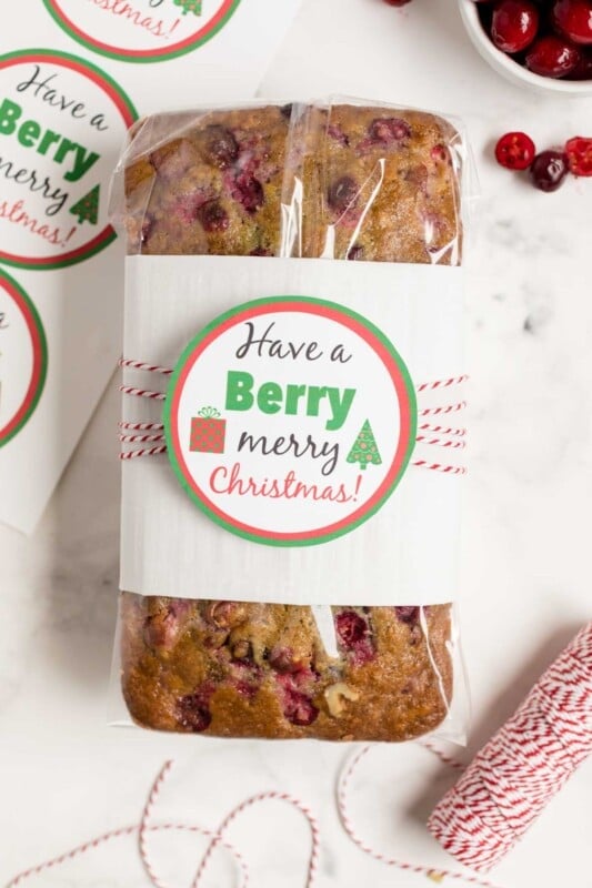 Berry holiday gift tag wrapped around a loaf of cranberry orange bread