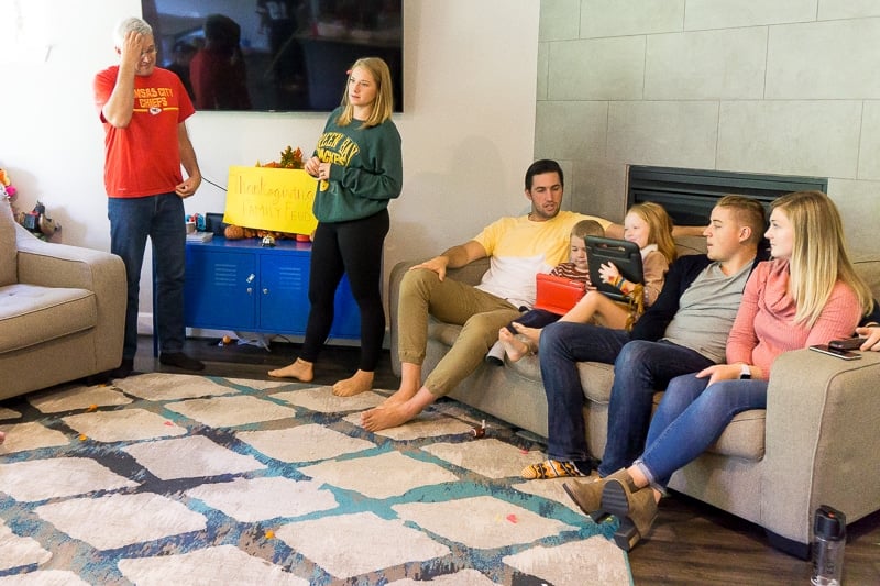 A family sitting in a family feud game at home