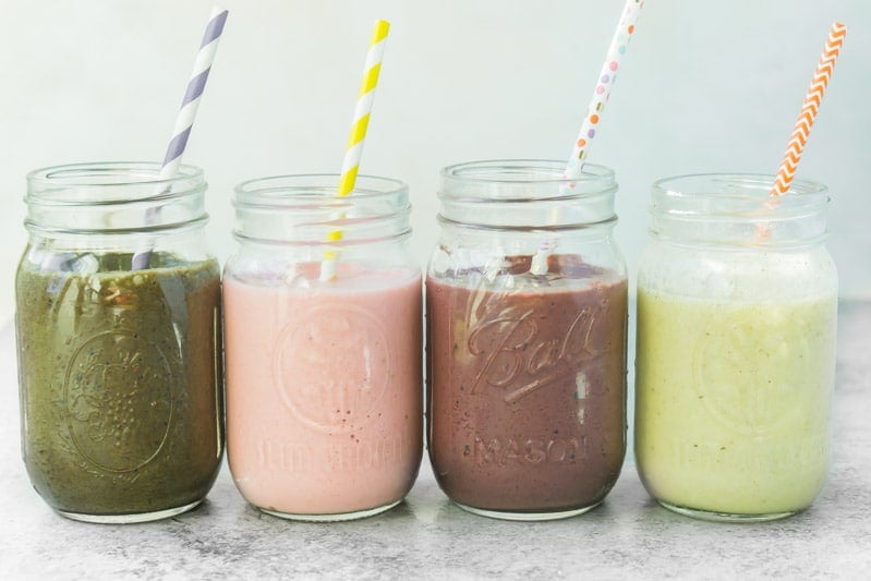 Four healthy smoothie recipes all lined up together