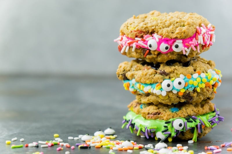 Monster cookie sandwiches stacked in a Halloween party food display