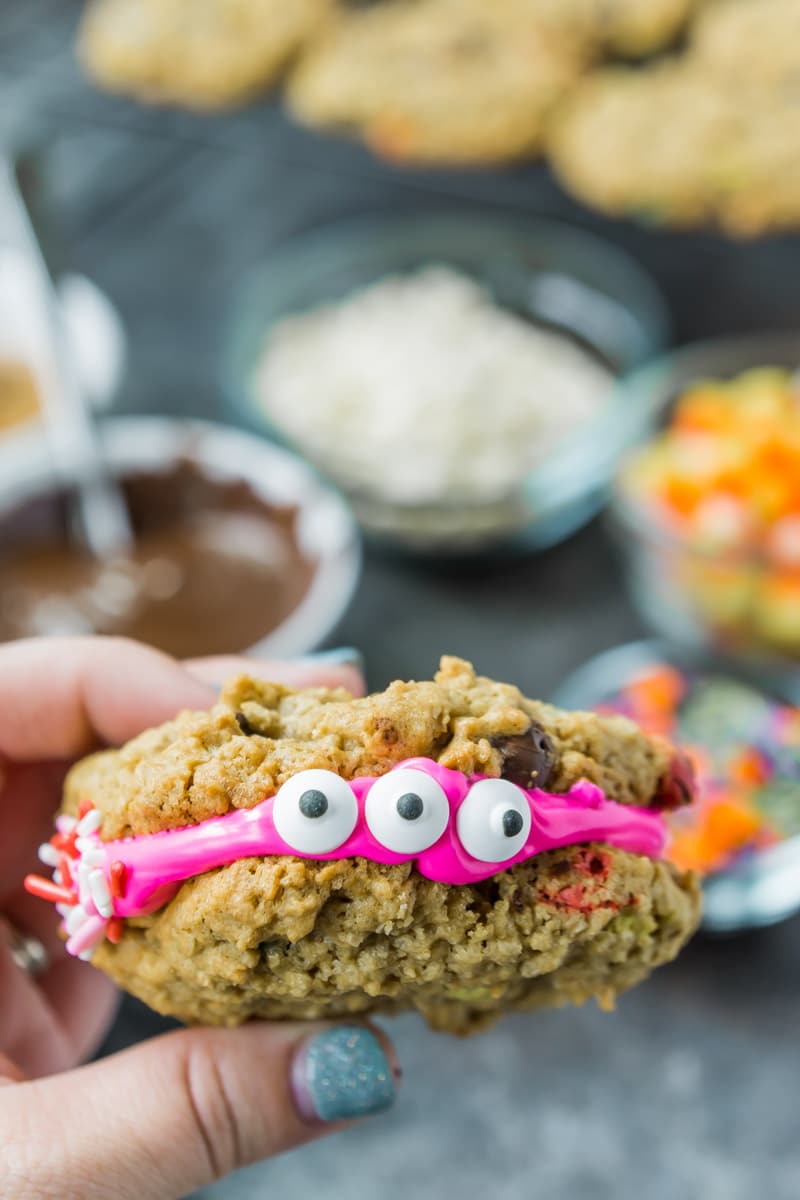 A monster cookie sandwich with two candy eyes