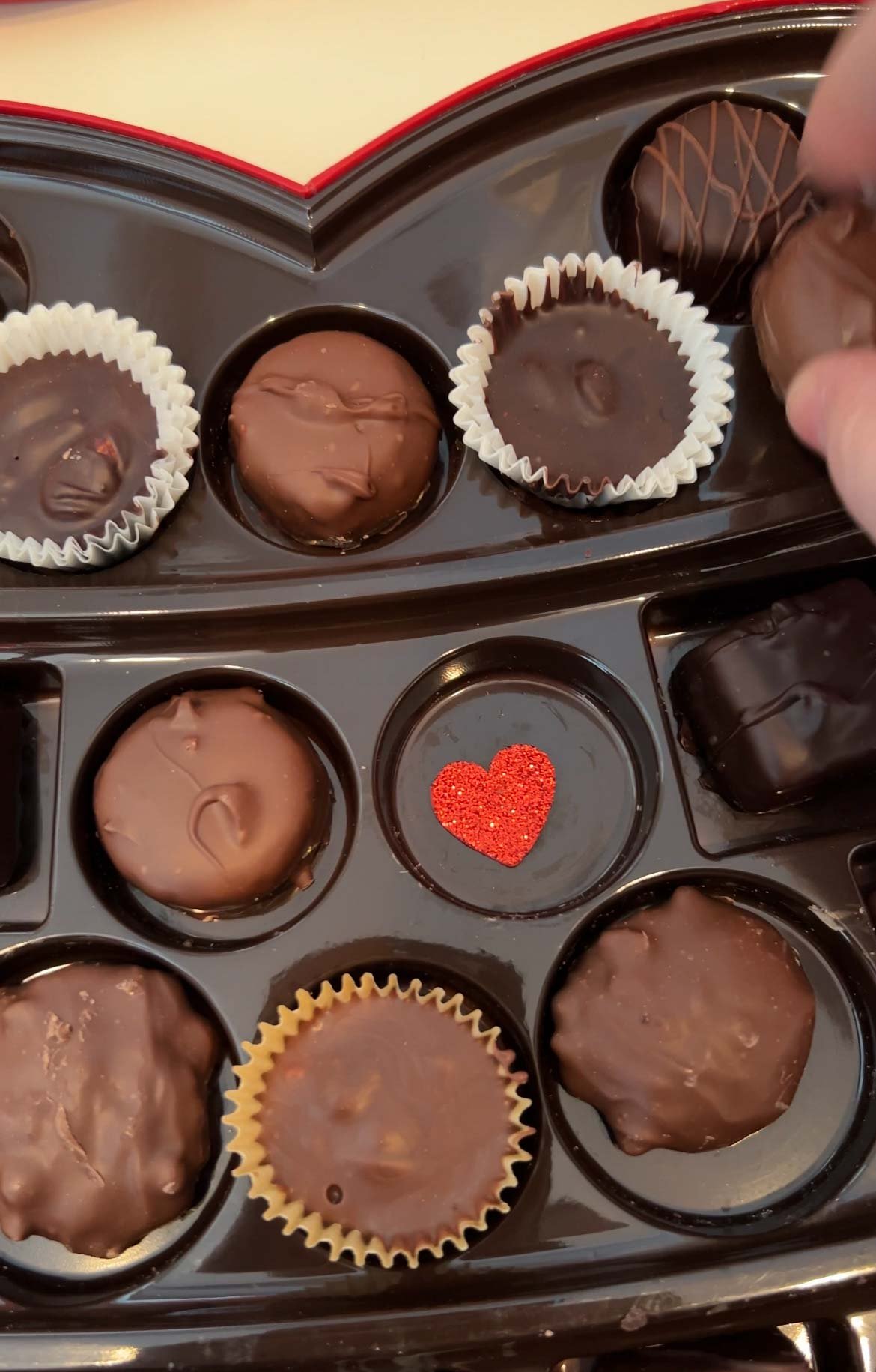 box of chocolates with a heart sticker inside