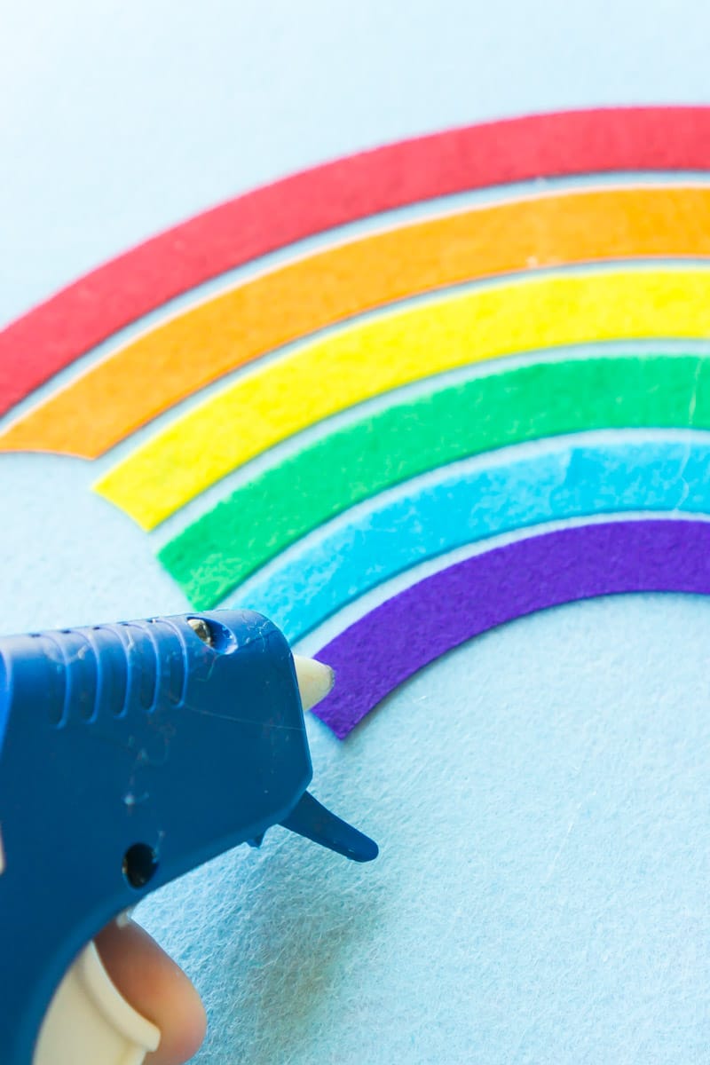 Gluing a felt rainbow onto a DIY St Patrick's Day pot of gold game