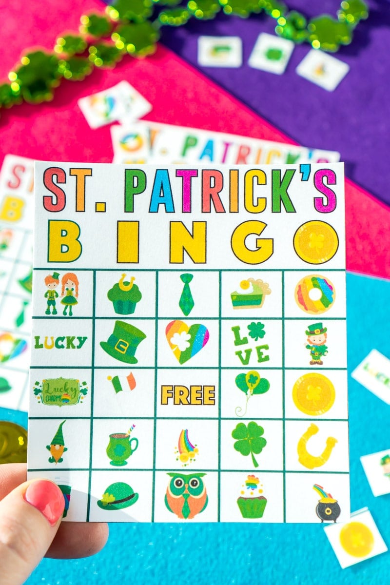 A hand holding one of many St. Patrick's Day bingo cards