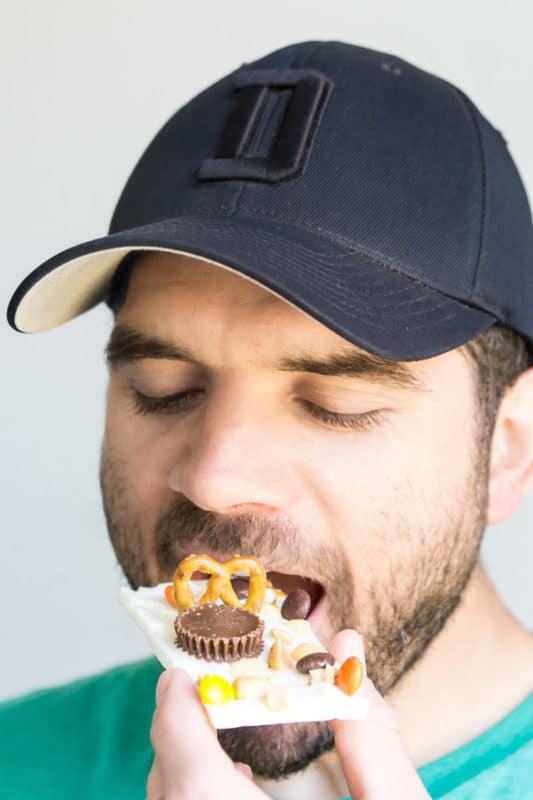 Man eating white chocolate Reese's bark