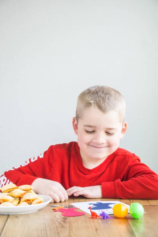 Kid at a table playing free dinosaur games