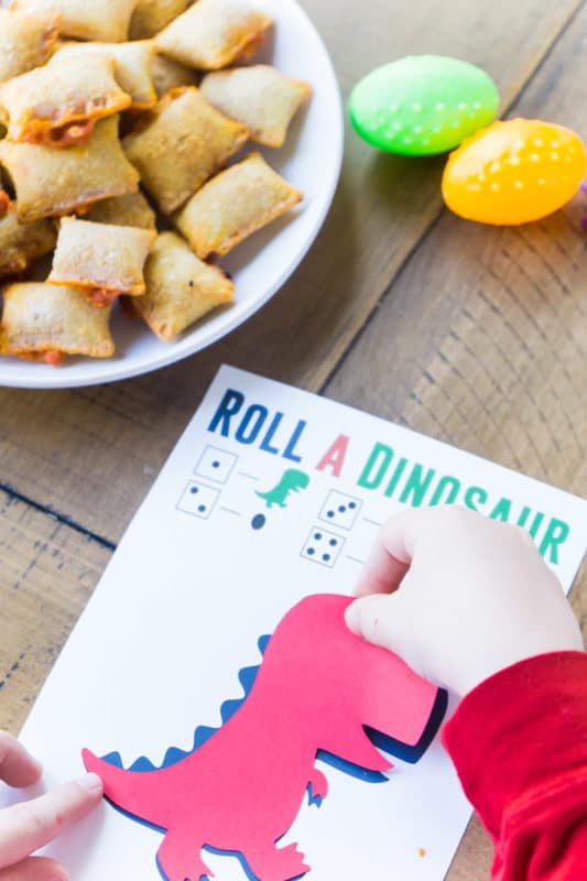 Kid playing roll the dinosaur game