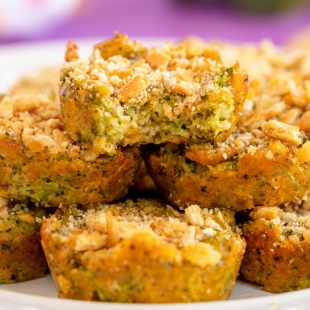 stacked pile of broccoli bites on a white cake stand
