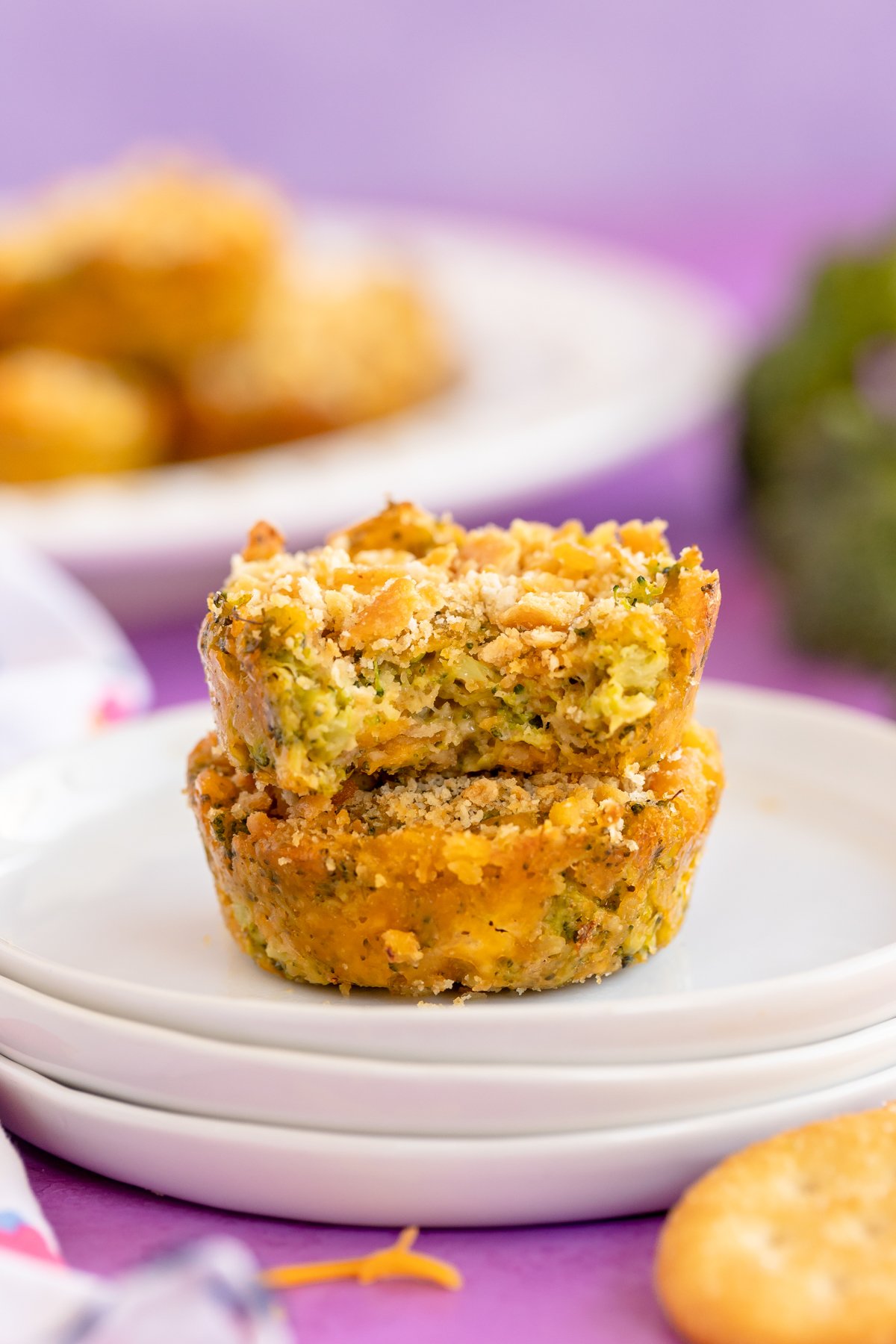 stacked broccoli bites on a white plate