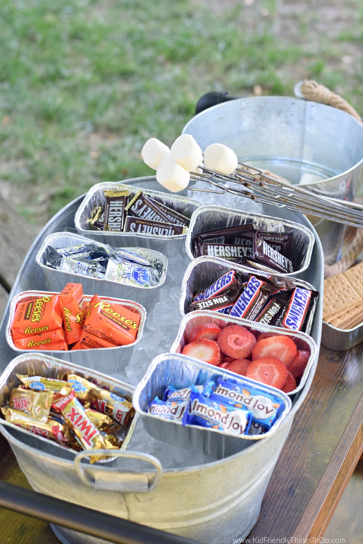 summer s'mores bar with chocolates in containers on ice