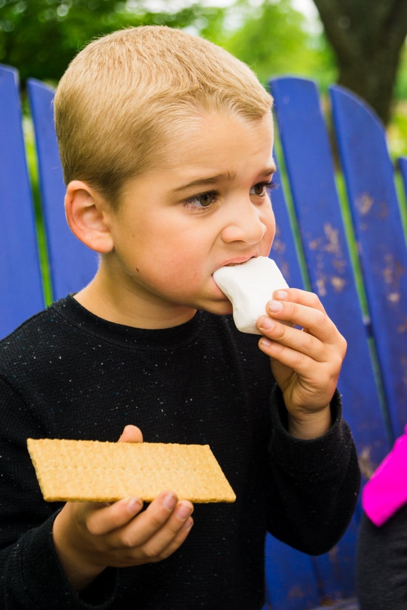 Eating marshmallows off a s'mores bar