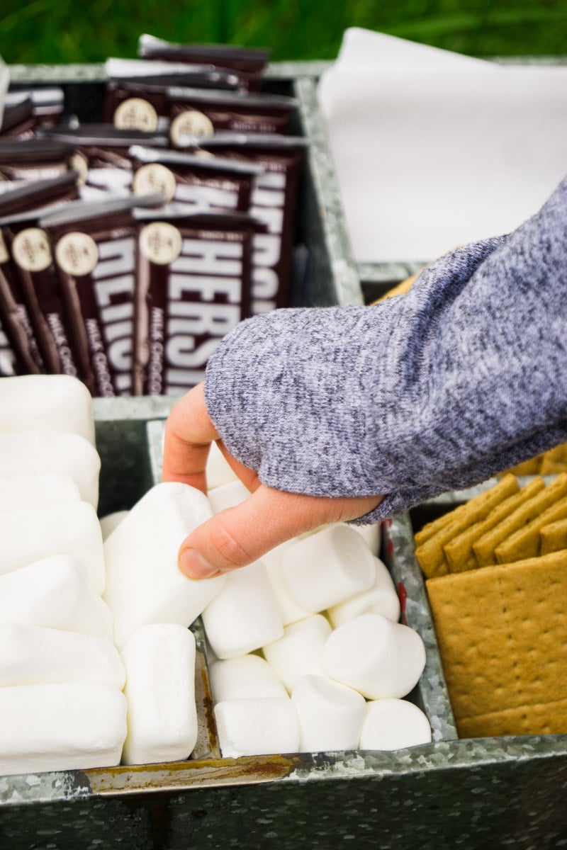 Grabbing marshmallow from a s'mores bar