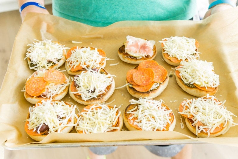 A tray filled with finished English muffin pizza options