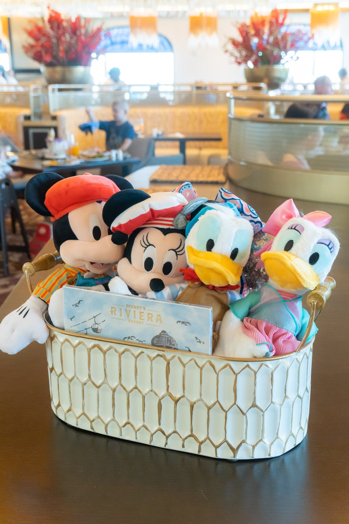 Basket with plush Mickey, Minnie, Daisy, and Donald