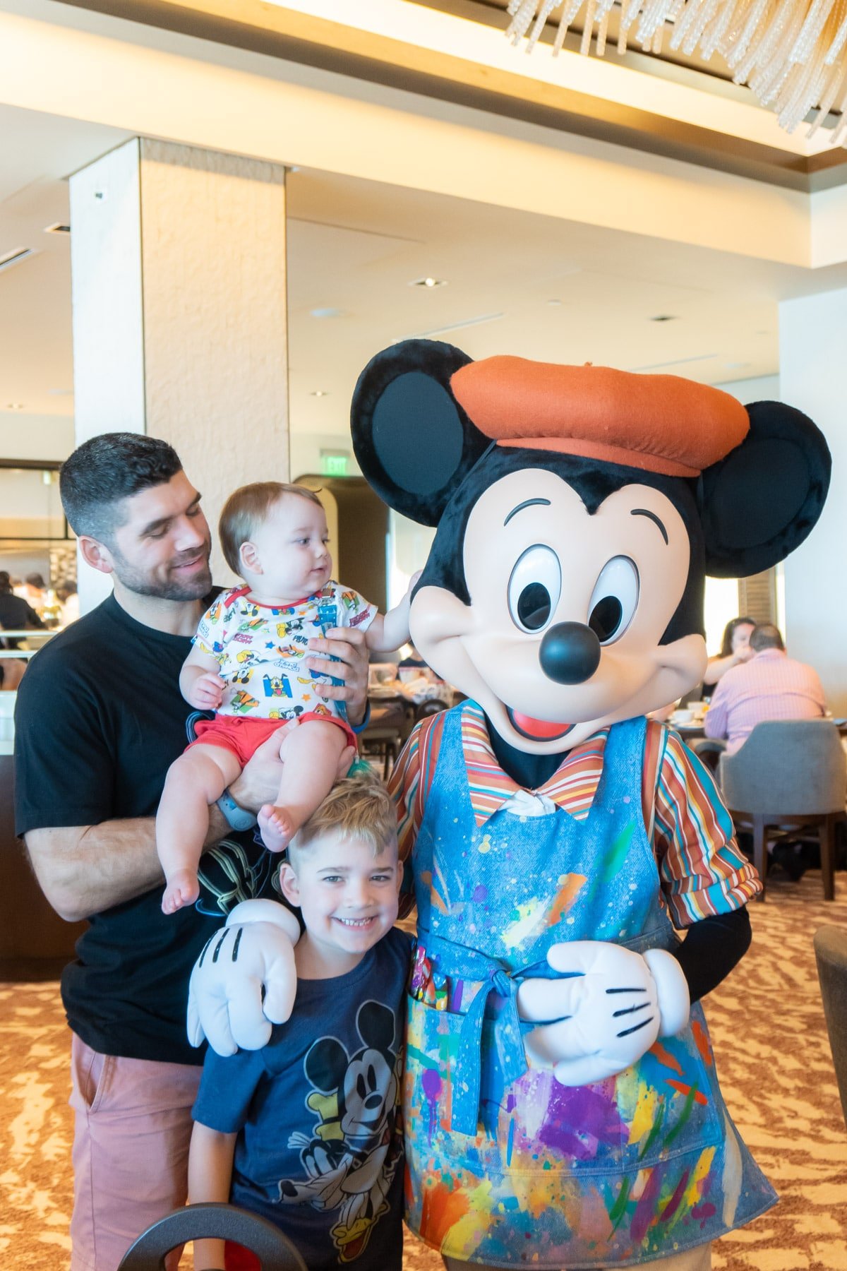 Family with Mickey Mouse in painter's outfit