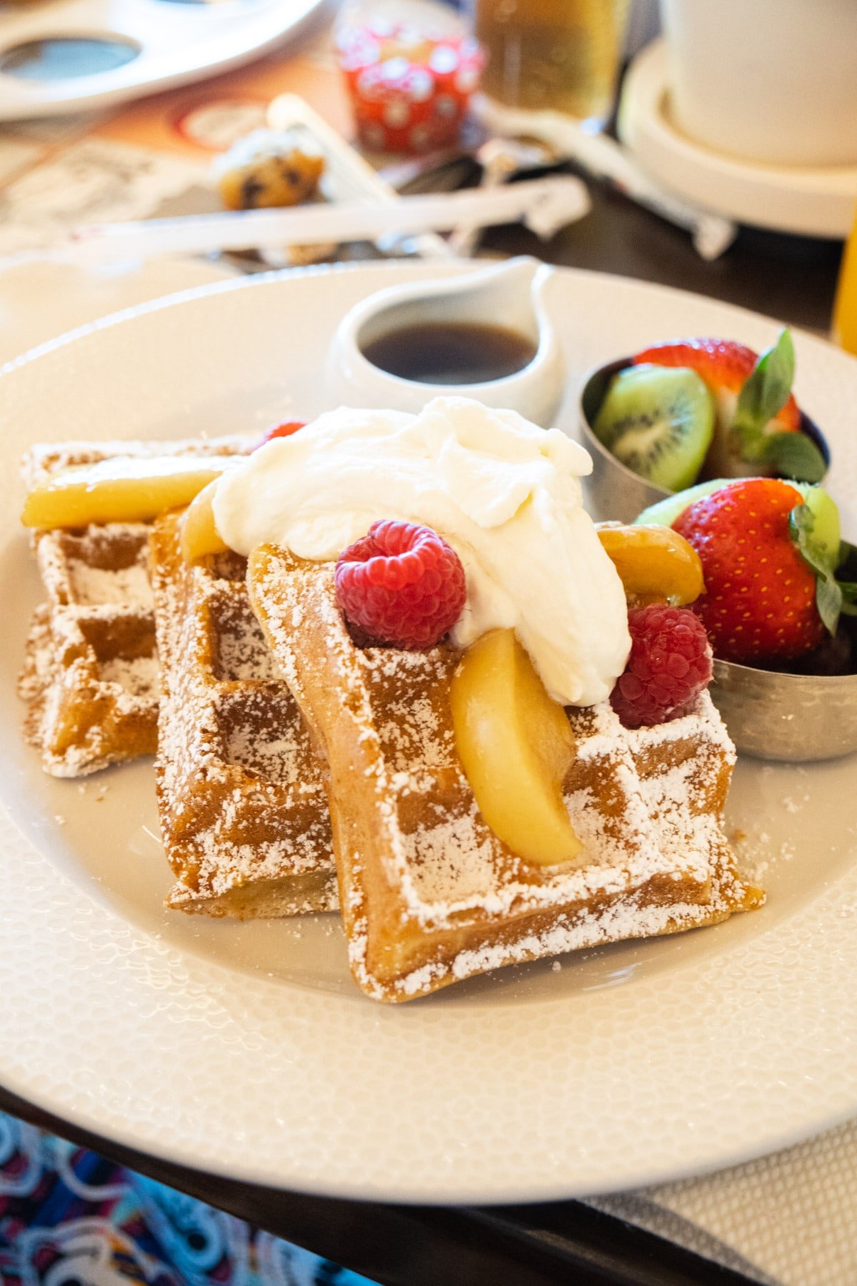 Waffle with sour cream whipped cream fruit and syrup