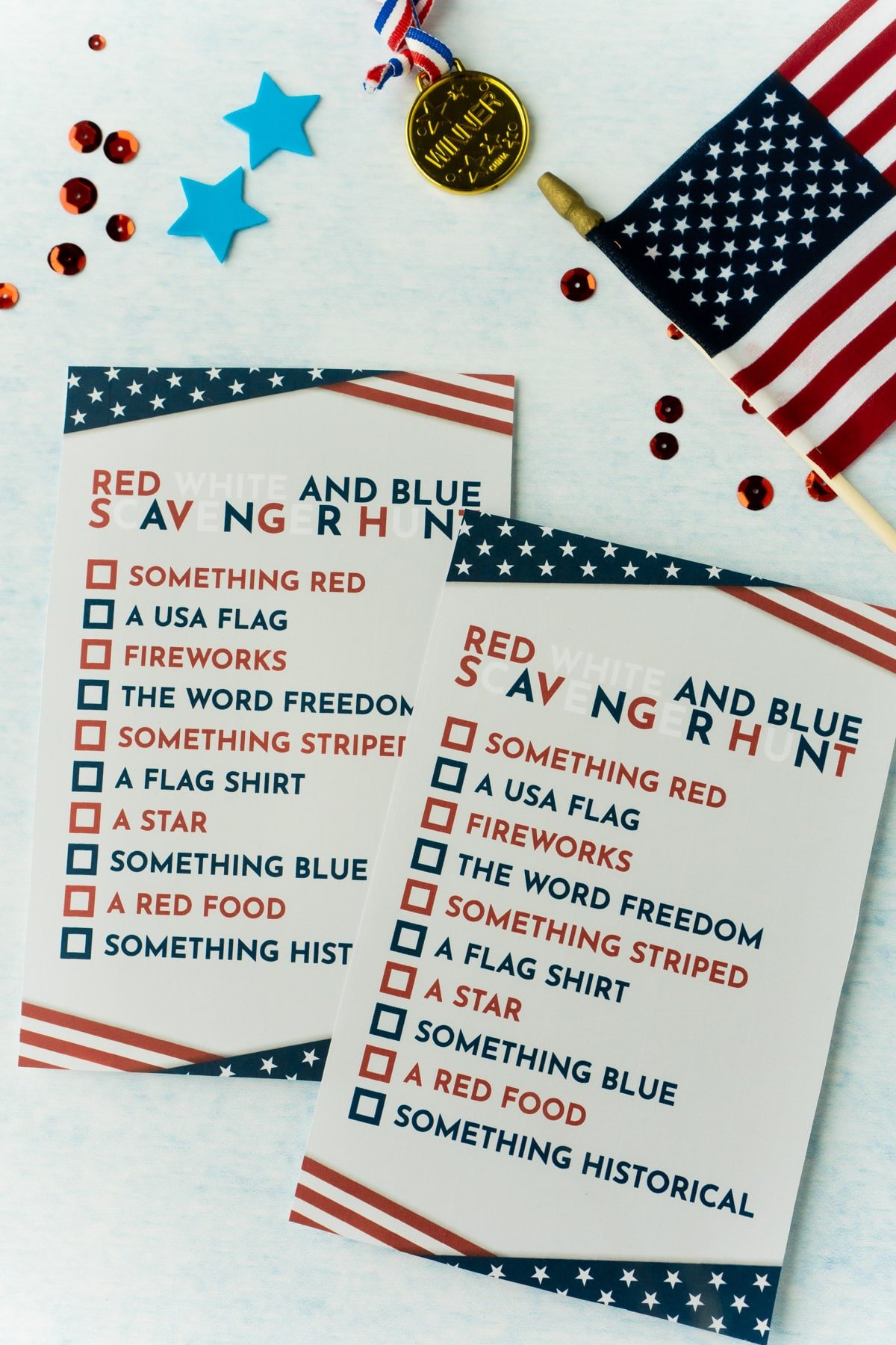 Two printed 4th of July scavenger hunt cards with a flag and confetti