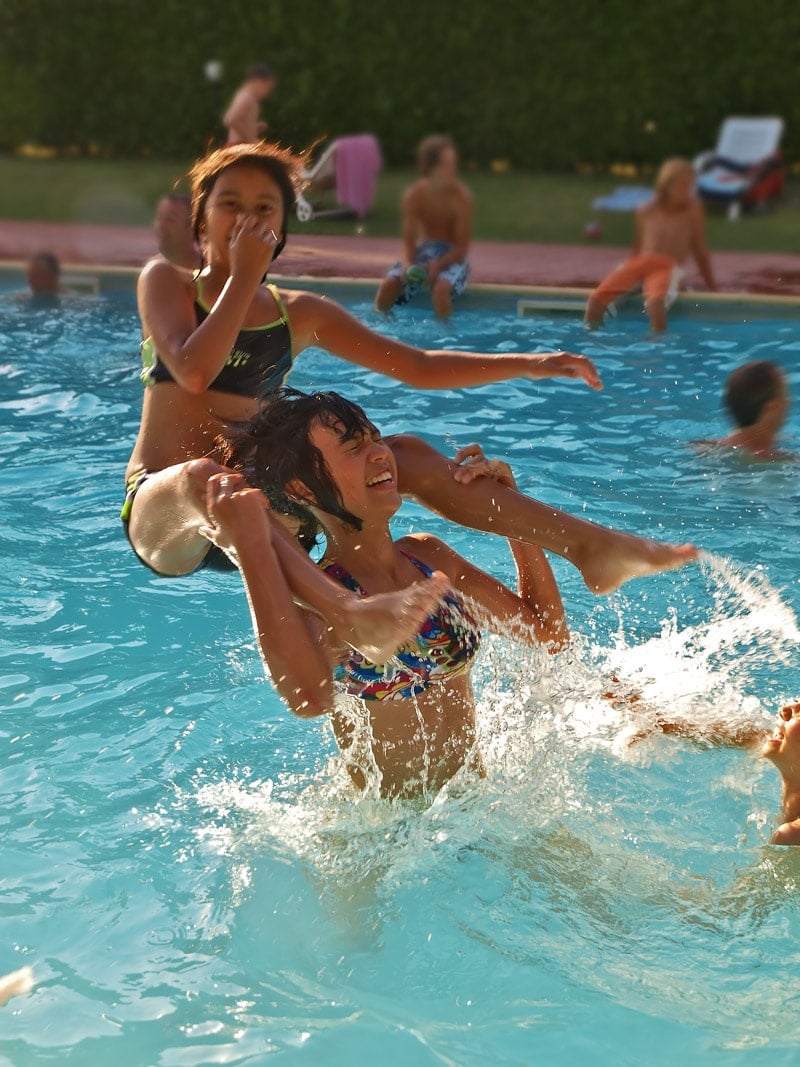 Kids having fun playing swimming pool games