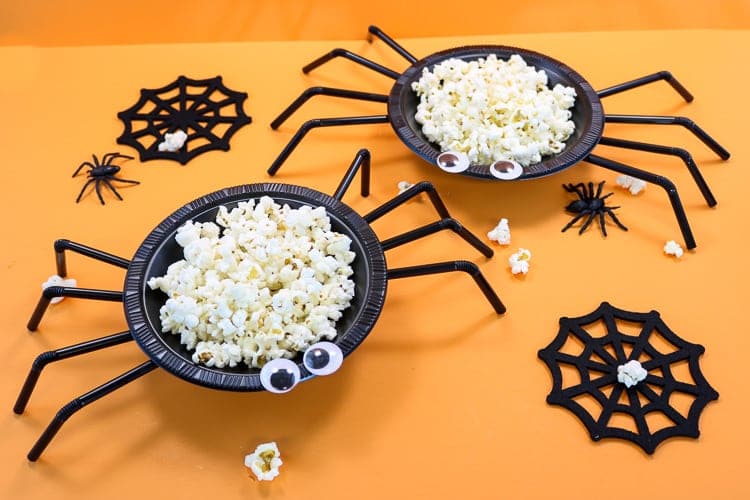 Spider treat bowls with Halloween party food inside