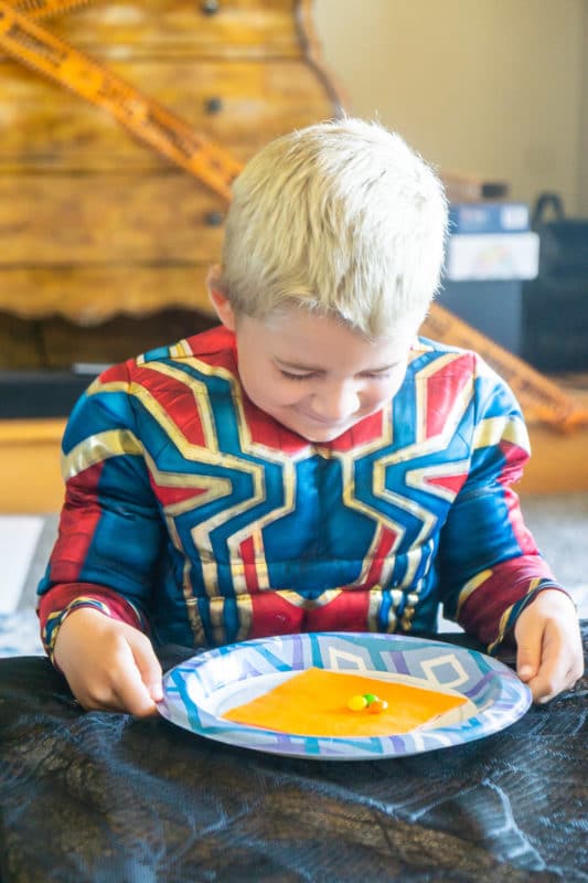 Kid playing Halloween guess the food game