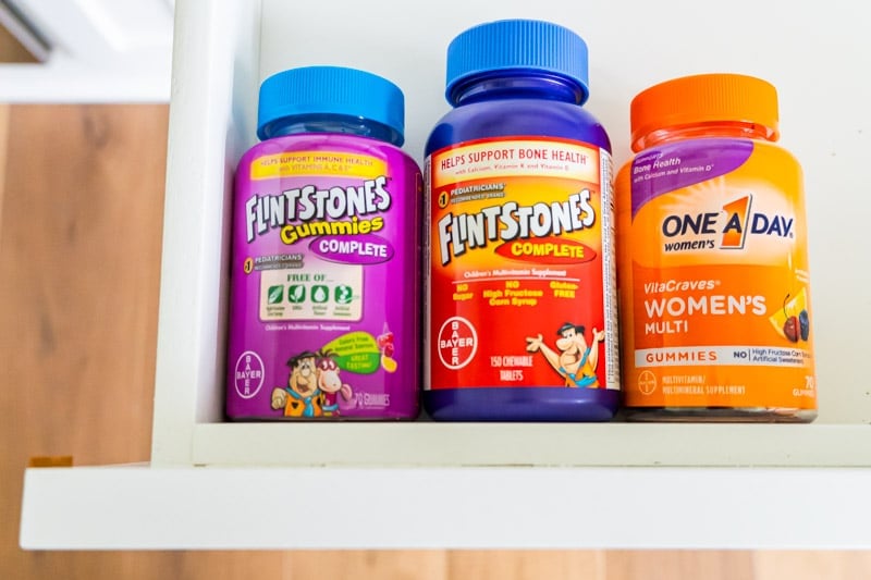 Vitamins in a drawer next to a chore chart