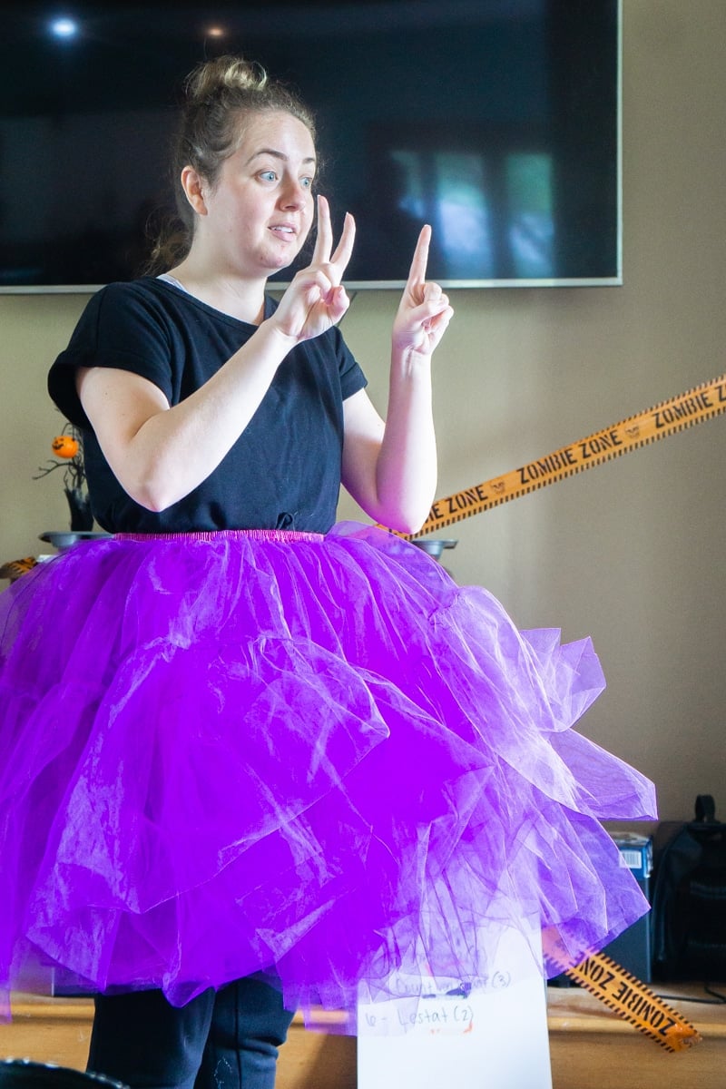 Girl in tutu playing Halloween charades