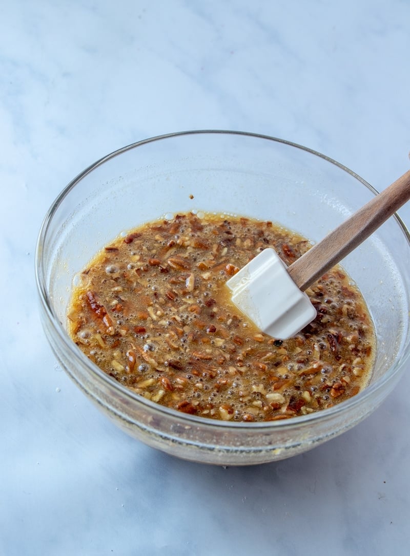 Mixing in pecans for pecan pie bars