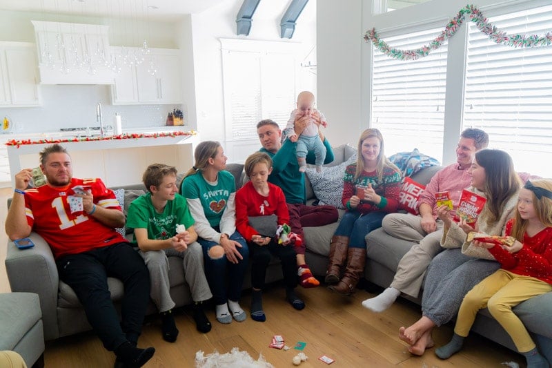 People holding saran wrap game prizes