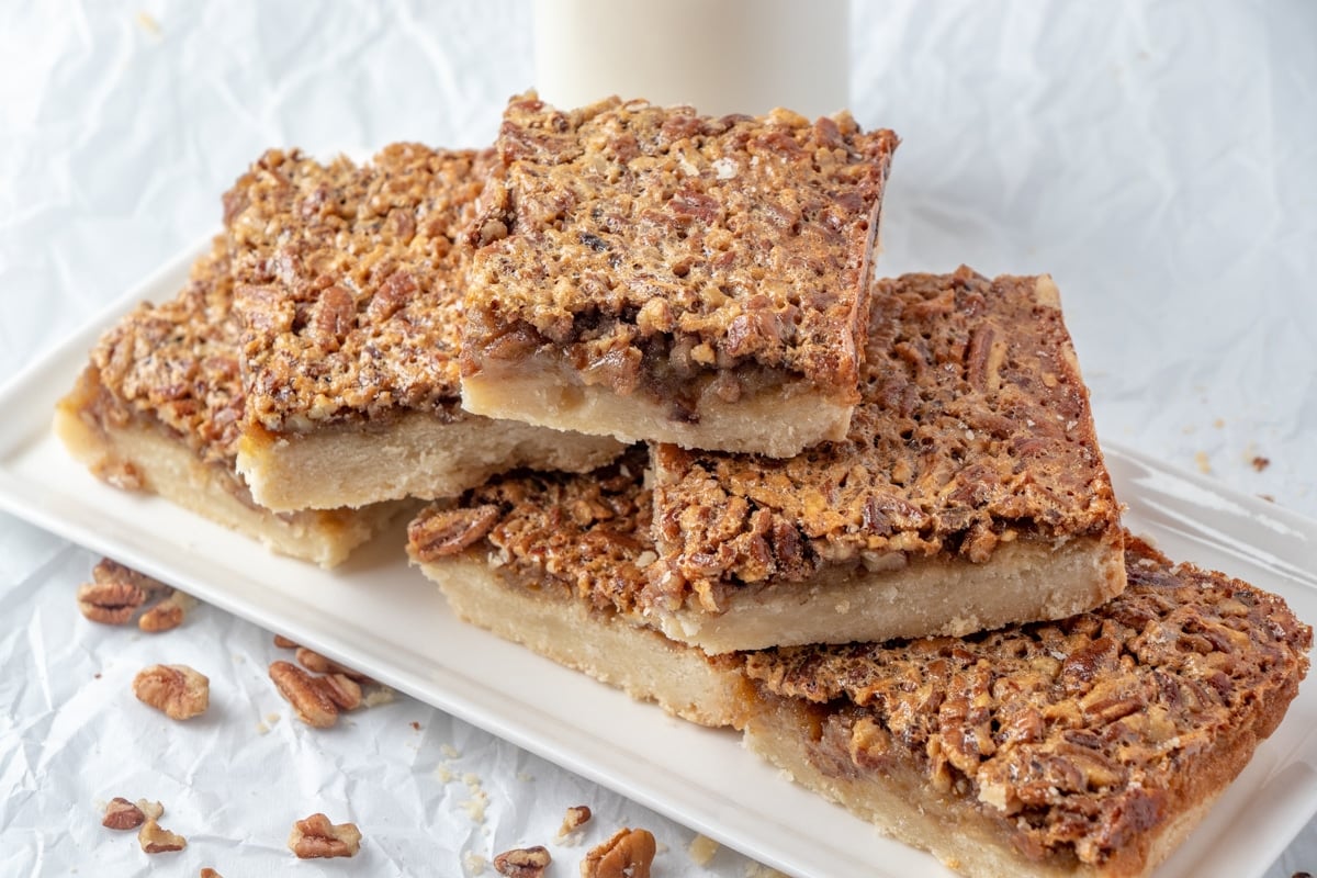 Stacked pecan pie bars with milk