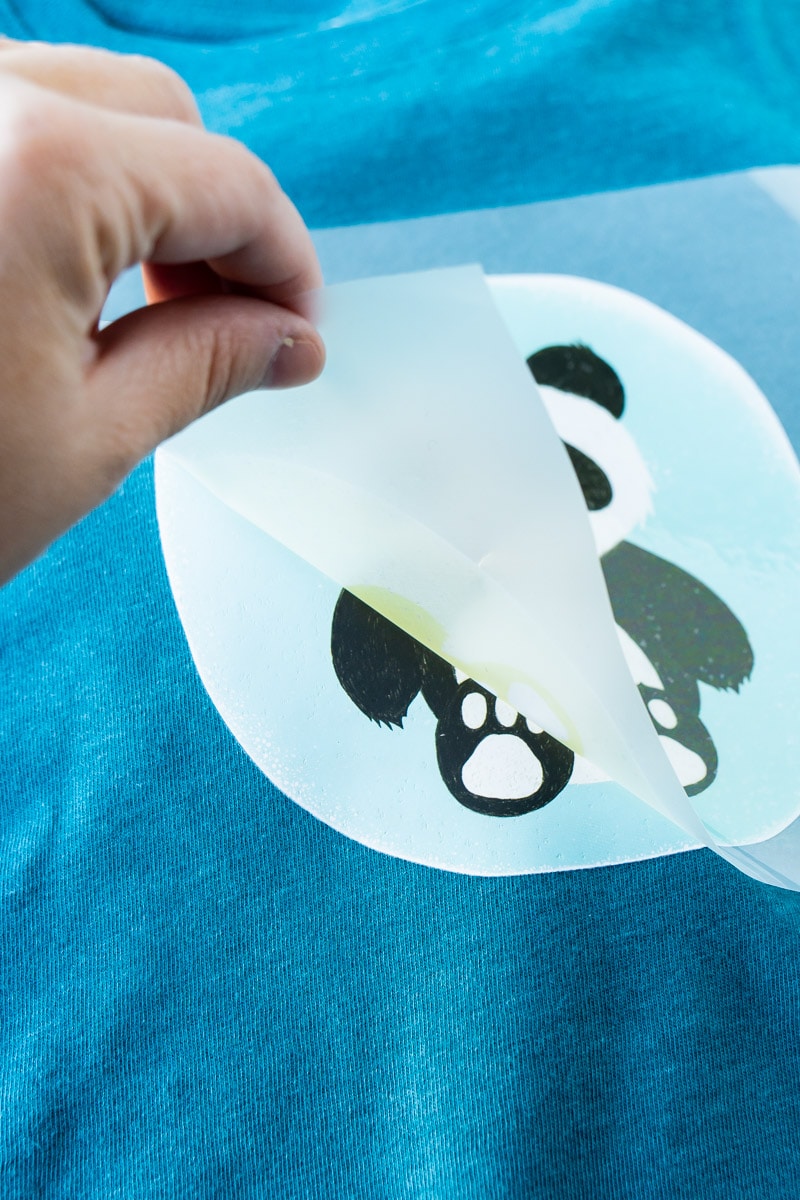 Peeling off iron-on vinyl while making personalized gifts for kids