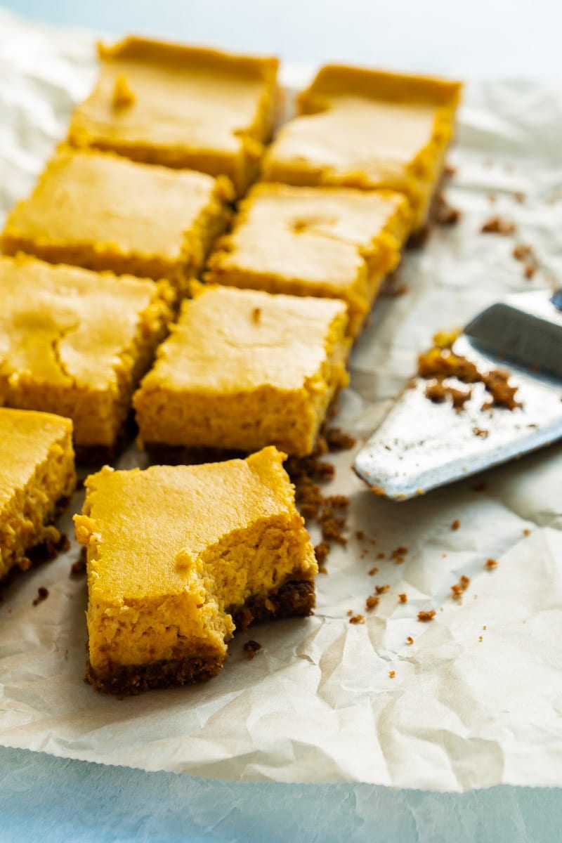 cut pumpkin cheesecake bars with a graham cracker crust