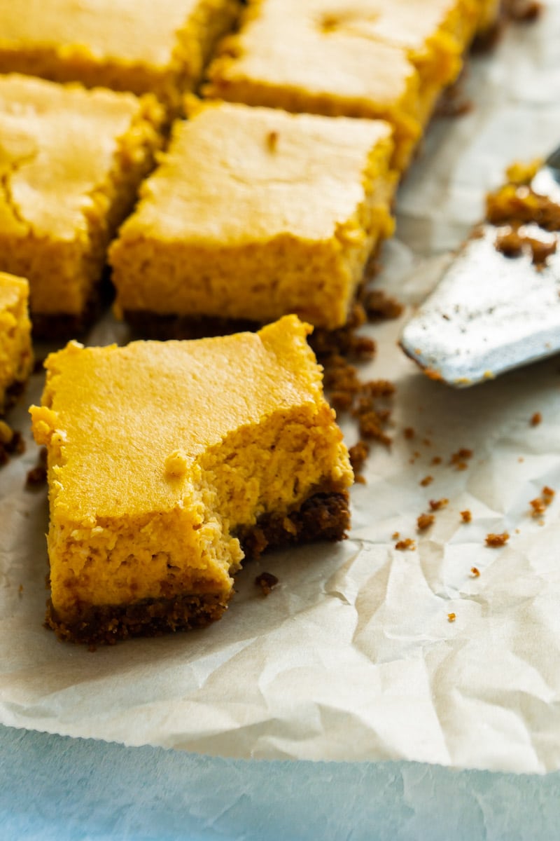 individual pumpkin cheesecake bars with a graham cracker crust