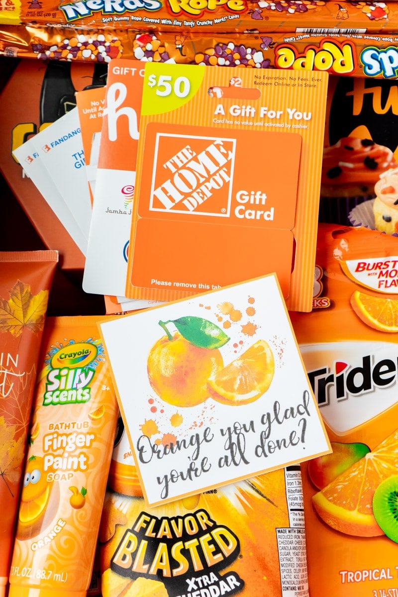 Orange gift tags with a basket full of items