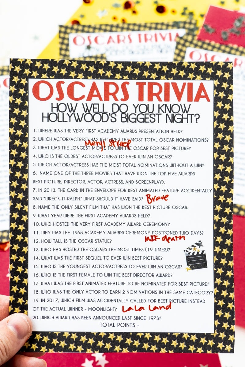 Oscar trivia game held in someone's hand