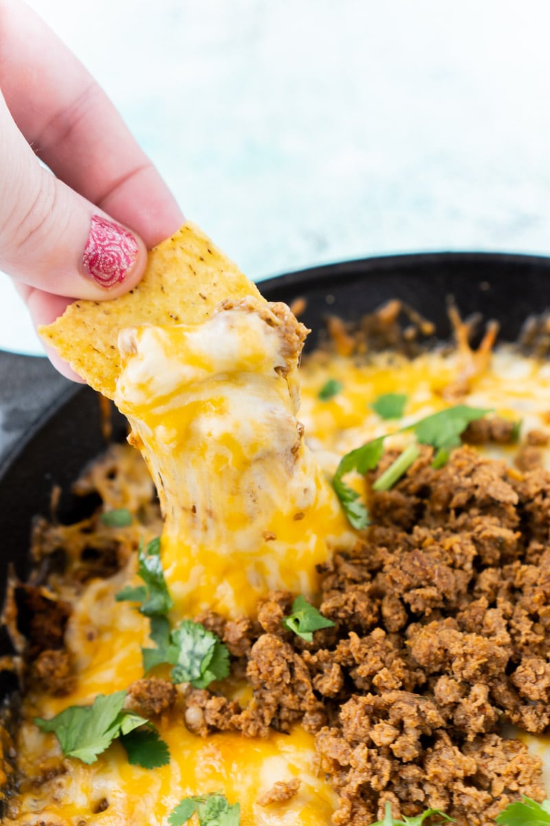 Chip dipped in queso fundido with chorizo